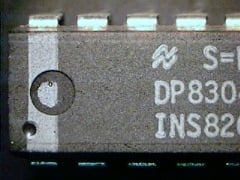 A grey part is showing with light-grey markings S=, DP830 and INS82 and a light-grey vertical paint line is visible. The paint is also visible inside the indent